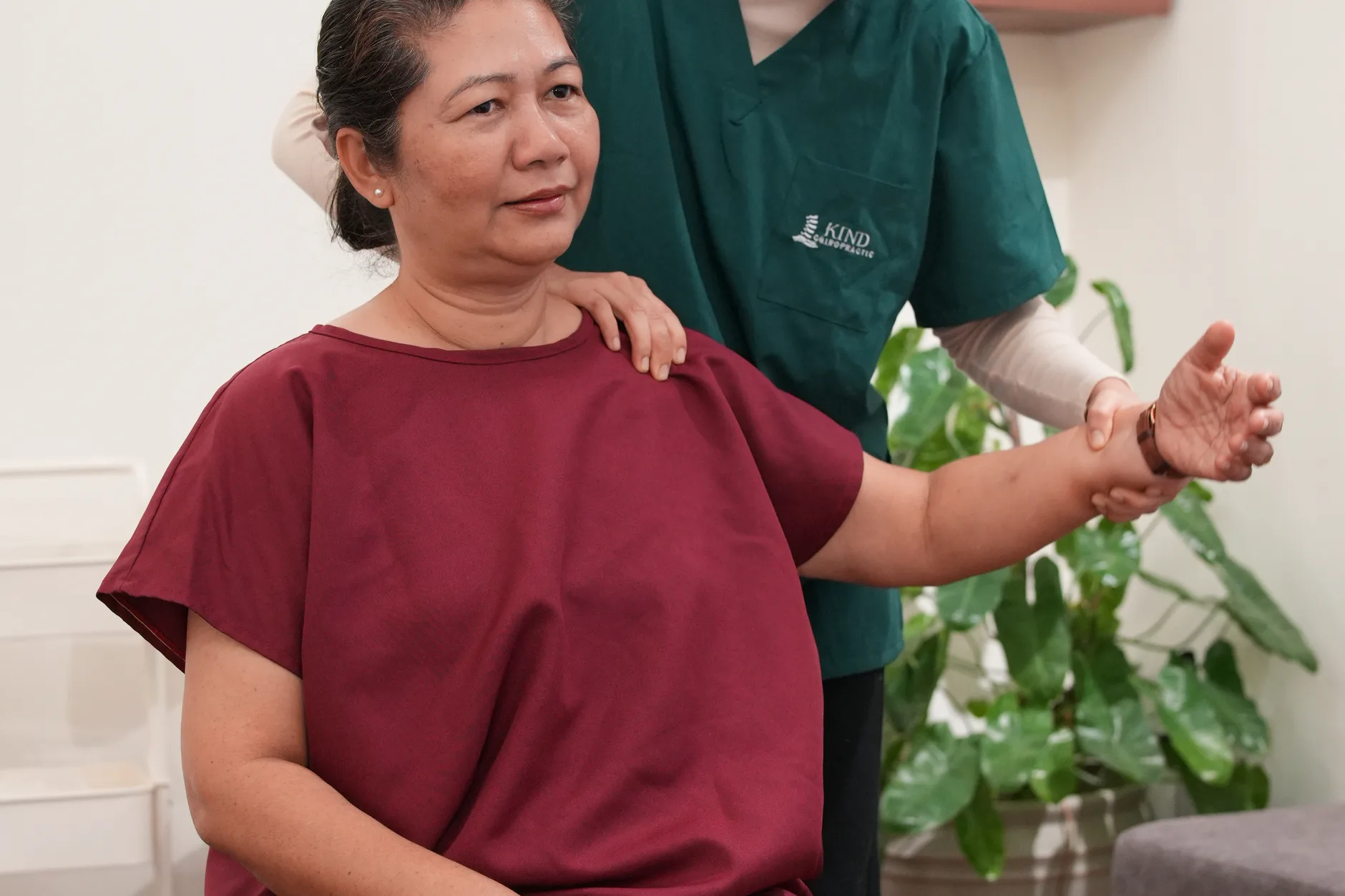 Chiropractor performing a gentle adjustment on a patient lying on a treatment table