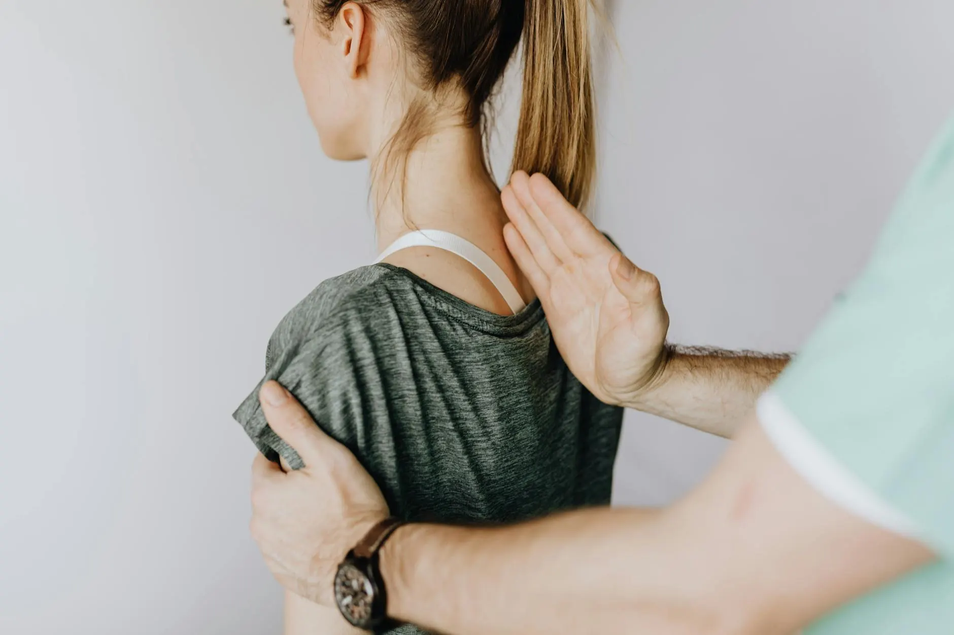 Chiropractor examining a patient spine during a pain relief consultation